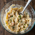 Mixing bold macaroni salad ingredients